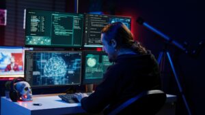 Hacker drinking coffee while running artificial intelligence spyware software